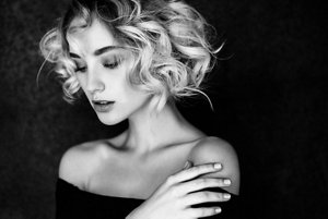 Beautiful blonde woman with bobbed curly hair 